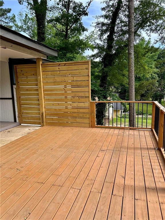 6072 Holiday Blvd, Forest Park, GA 30265 - wooden terrace featuring view of scattered trees