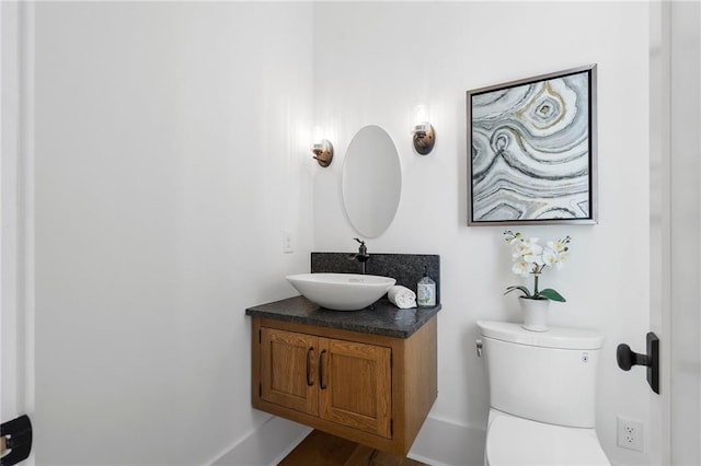 bathroom featuring vanity and toilet