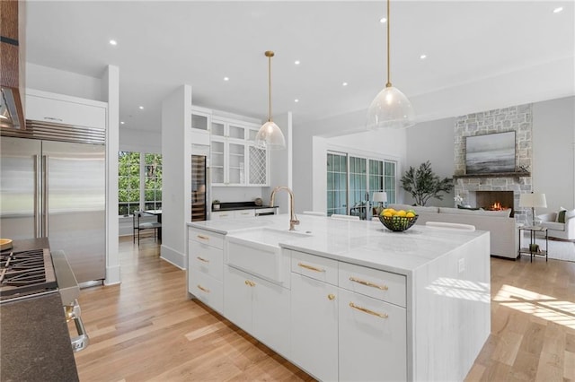 kitchen with white cabinets and an island with sink