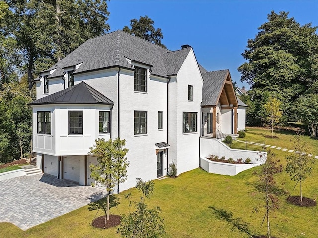 view of front of property with a front yard and a garage