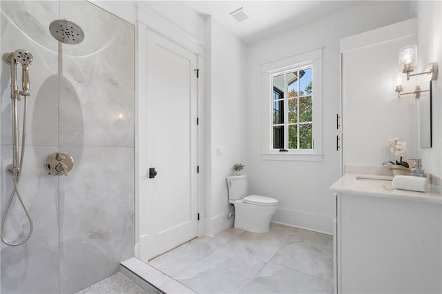 bathroom featuring a shower, vanity, and toilet