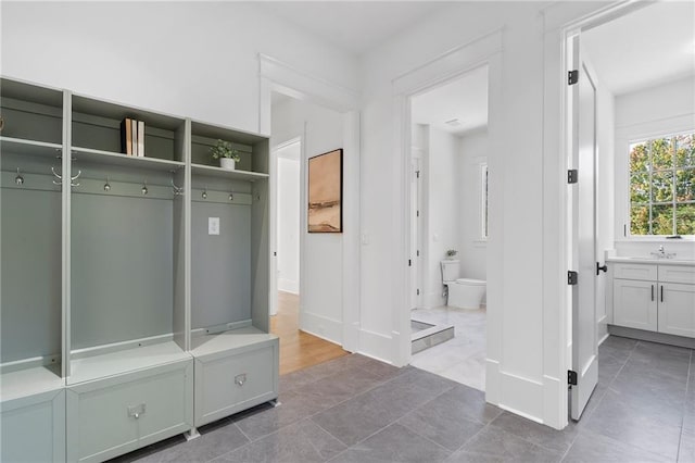 mudroom featuring tile patterned floors and sink