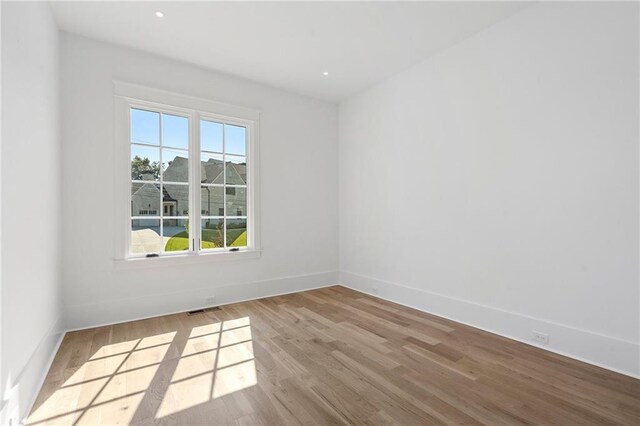 unfurnished room with light hardwood / wood-style floors