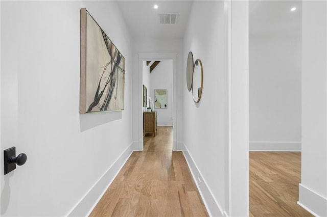 corridor with light hardwood / wood-style floors