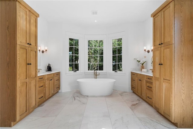 bathroom with a bathing tub and vanity