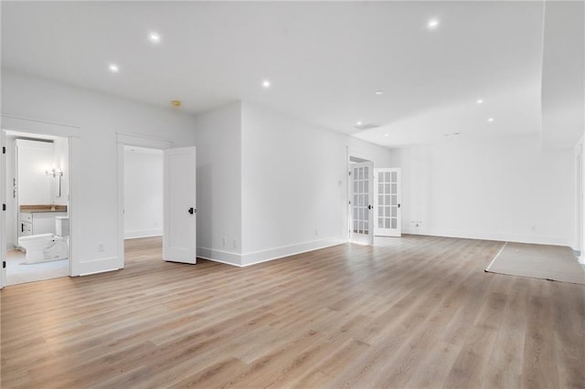 unfurnished living room with french doors and light hardwood / wood-style floors