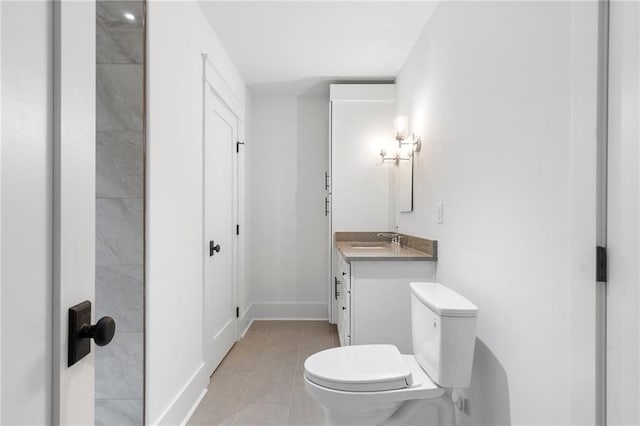 bathroom featuring tile patterned floors, vanity, and toilet