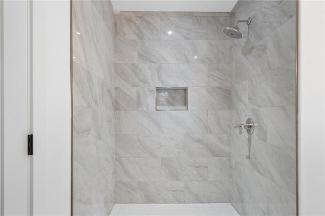 bathroom with a tile shower