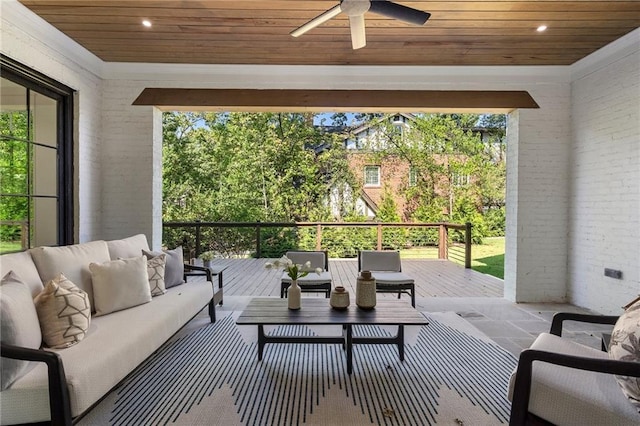 view of patio with outdoor lounge area, ceiling fan, and a wooden deck