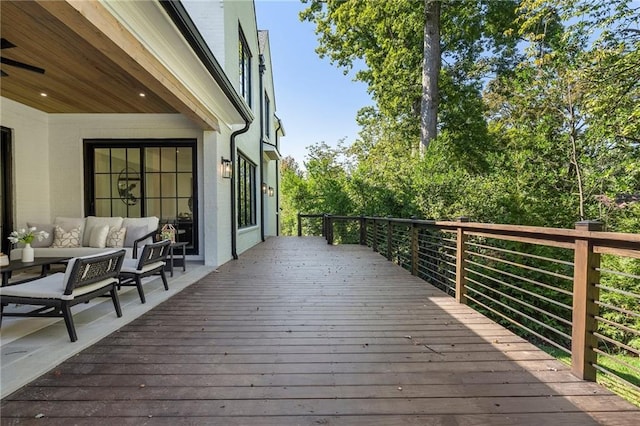 wooden terrace featuring an outdoor living space