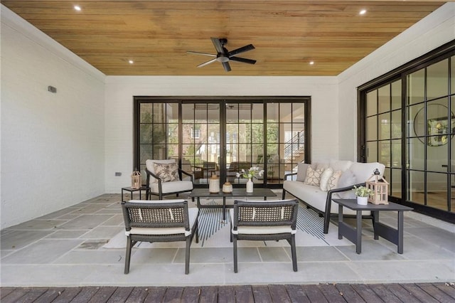 interior space featuring ceiling fan and wood ceiling