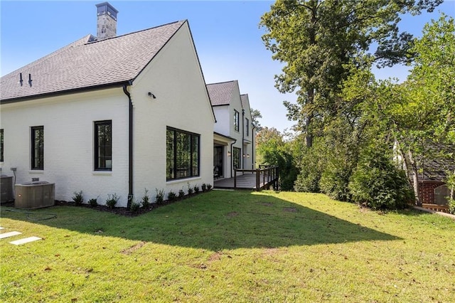 view of home's exterior featuring a yard and central air condition unit