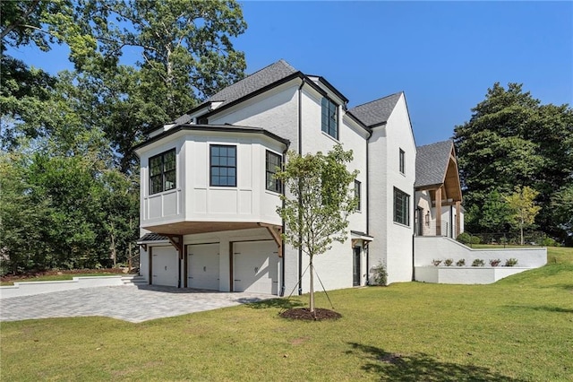 view of side of home featuring a lawn and a garage