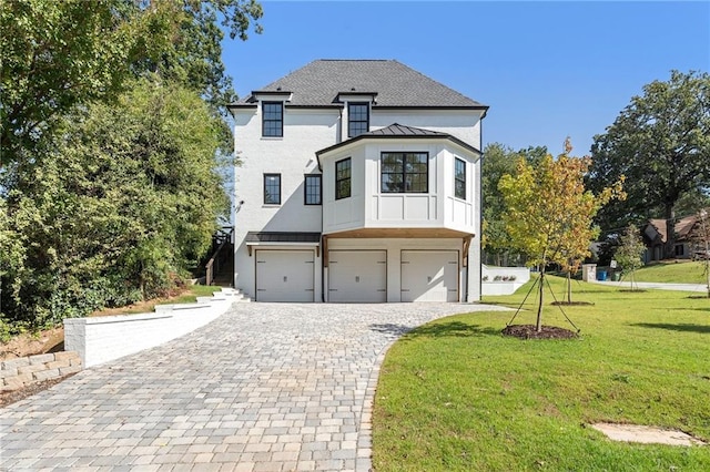 view of front of house featuring a front yard and a garage