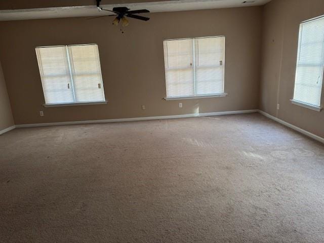 unfurnished room featuring ceiling fan and light carpet