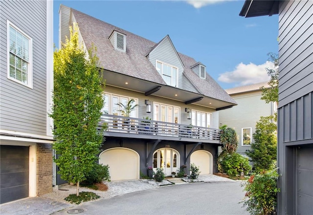 view of front of property featuring a garage and a balcony