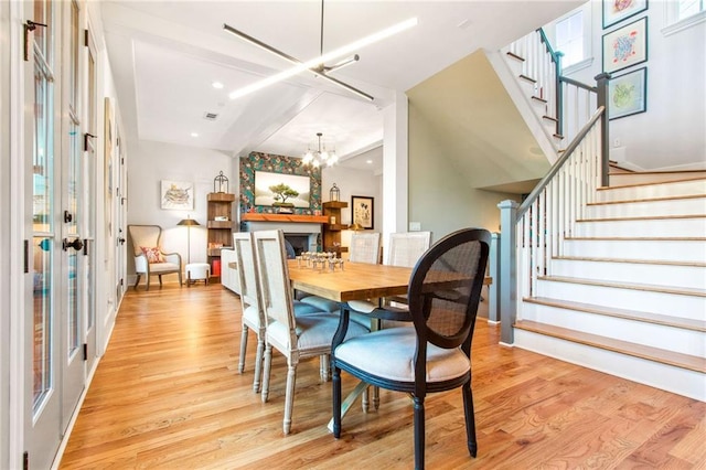 dining area with a chandelier and light hardwood / wood-style floors