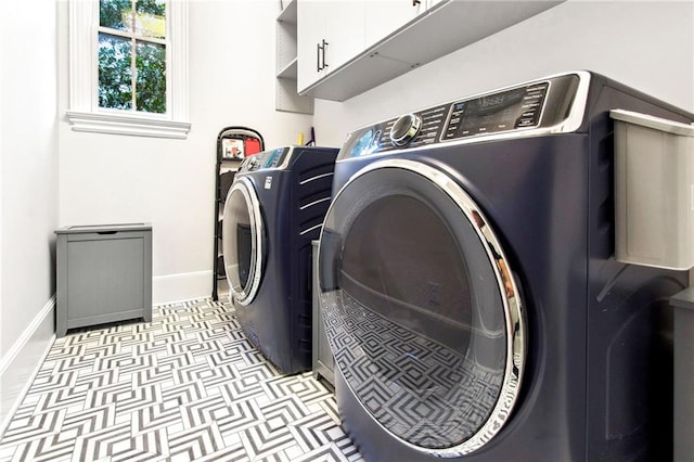 washroom featuring light tile patterned flooring, cabinets, and independent washer and dryer