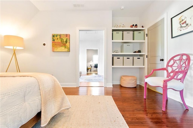 bedroom with dark wood-type flooring