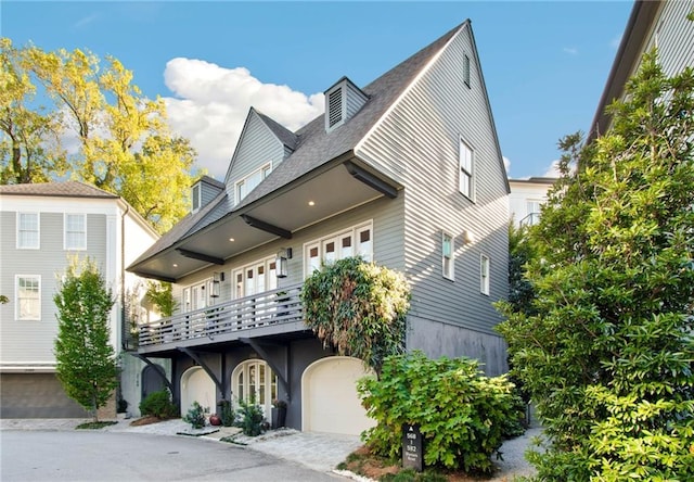 view of front of home featuring a garage and a balcony