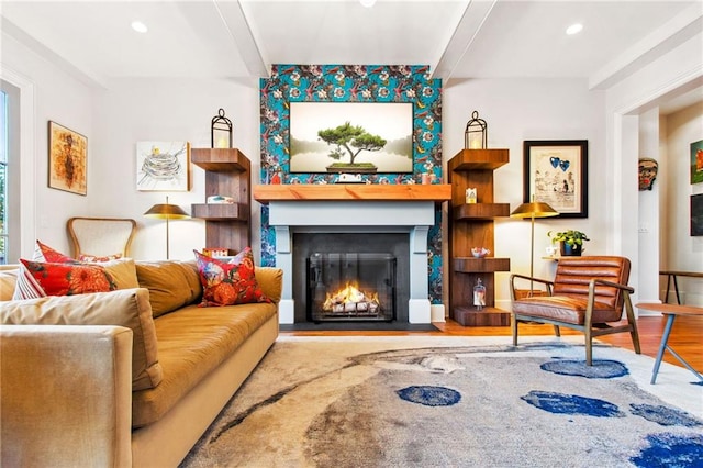 living area featuring beamed ceiling and wood-type flooring