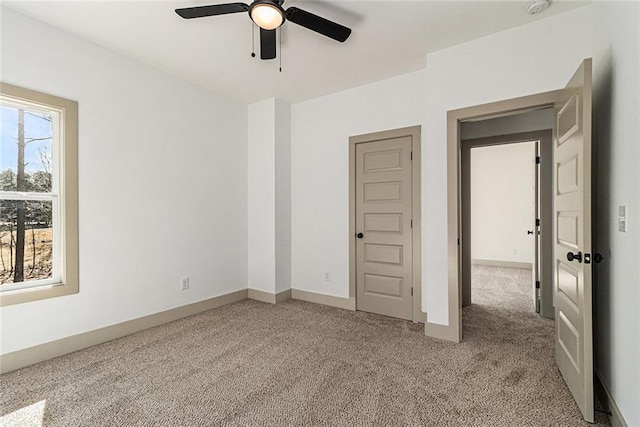 carpeted empty room with ceiling fan