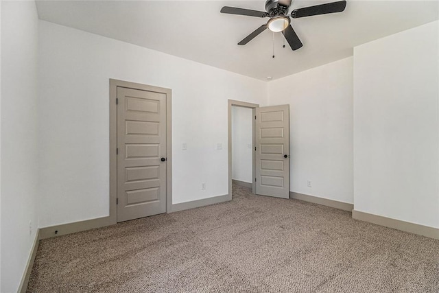 unfurnished bedroom featuring light colored carpet and ceiling fan