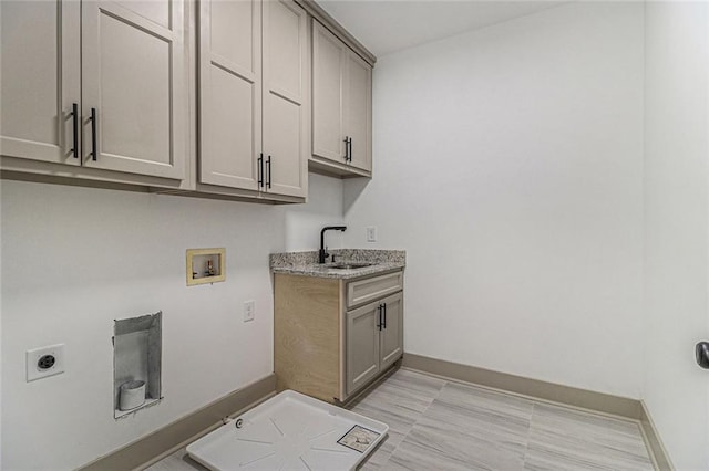 washroom with cabinets, washer hookup, hookup for an electric dryer, and sink