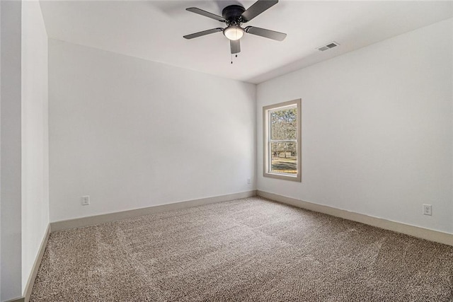 carpeted spare room featuring ceiling fan