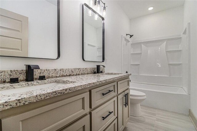 full bathroom with toilet, vanity, and bathtub / shower combination