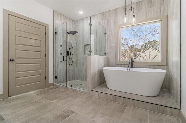 bathroom featuring separate shower and tub