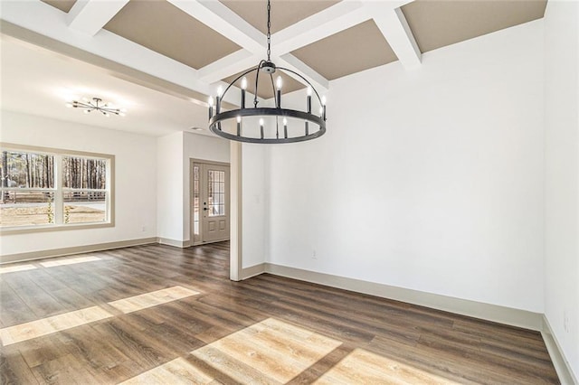 unfurnished dining area featuring beamed ceiling, coffered ceiling, dark wood-type flooring, and a chandelier