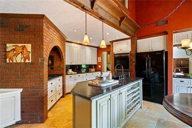 4820 Coppedge Trl, Peachtree Corners, GA 30096 - kitchen with black appliances, stone tile flooring, a sink, a kitchen island with sink, and pendant lighting