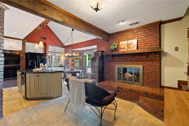 4820 Coppedge Trl, Peachtree Corners, GA 30096 - living area with a textured ceiling, a fireplace, ornamental molding, a chandelier, and light stone finish floors
