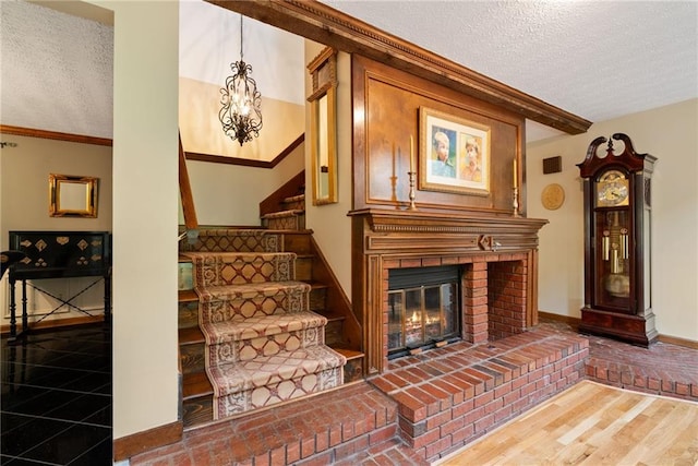 4820 Coppedge Trl, Peachtree Corners, GA 30096 - unfurnished living room featuring a textured ceiling, a brick fireplace, stairway, baseboards, and wood finished floors
