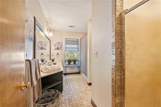 4820 Coppedge Trl, Peachtree Corners, GA 30096 - bathroom with vanity, tile patterned floors, a textured ceiling, a shower, and baseboards
