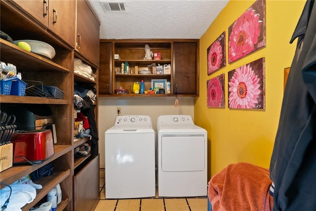 4820 Coppedge Trl, Peachtree Corners, GA 30096 - laundry area with cabinet space, separate washer and dryer, a textured ceiling, and light tile patterned floors