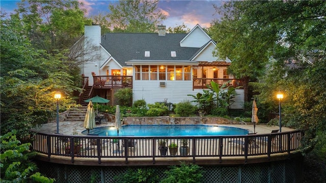 4820 Coppedge Trl, Peachtree Corners, GA 30096 - back of house with stairway, a deck, an outdoor pool, and a chimney