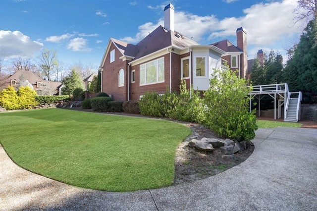 821 Camden Park Ct, Atlanta, GA 30342 - view of home's exterior with stairway, brick siding, a yard, and a chimney