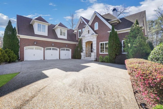 821 Camden Park Ct, Atlanta, GA 30342 - view of front of property with driveway, brick siding, an attached garage, and a chimney