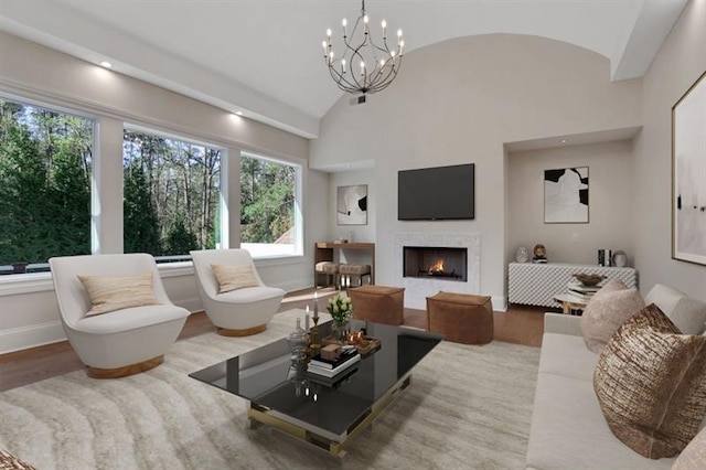 821 Camden Park Ct, Atlanta, GA 30342 - living room with lofted ceiling, a warm lit fireplace, a chandelier, and wood finished floors