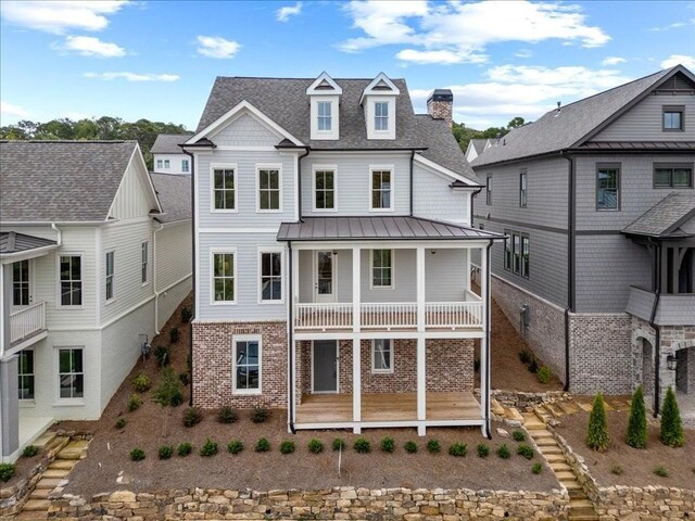 rear view of property featuring a balcony