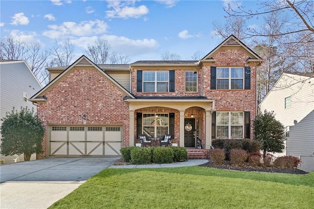 view of front of property with a porch, a garage, and a front lawn