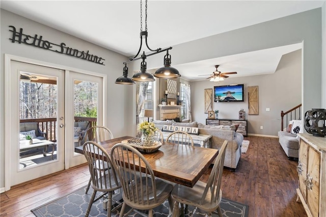 dining space with dark wood-type flooring, ceiling fan, and french doors