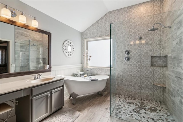 bathroom featuring hardwood / wood-style flooring, vanity, shower with separate bathtub, and vaulted ceiling