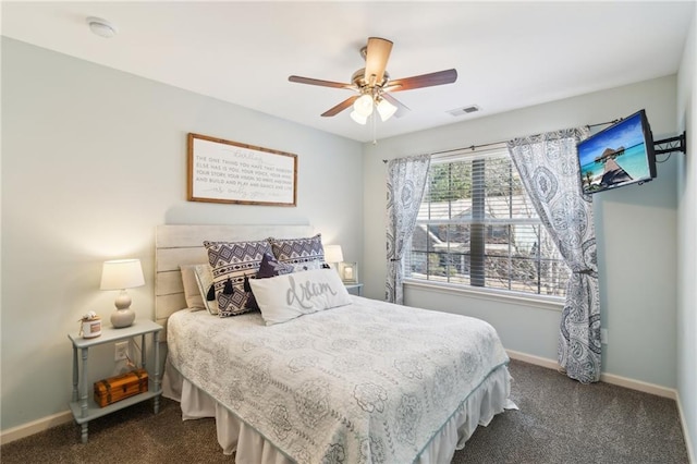 bedroom with ceiling fan and dark carpet