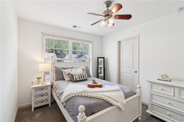 bedroom with ceiling fan and dark colored carpet