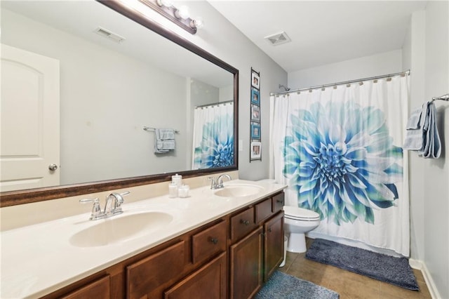 bathroom with vanity, tile patterned flooring, and toilet