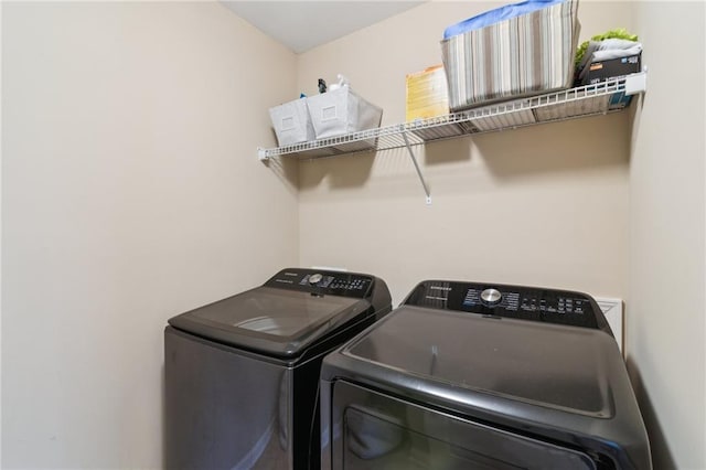 washroom featuring washing machine and dryer