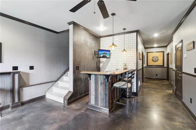 bar featuring crown molding, ceiling fan, and hanging light fixtures